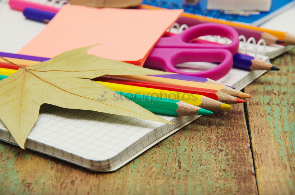 Similar – Notepads, papers, markers and other stationery on wooden table