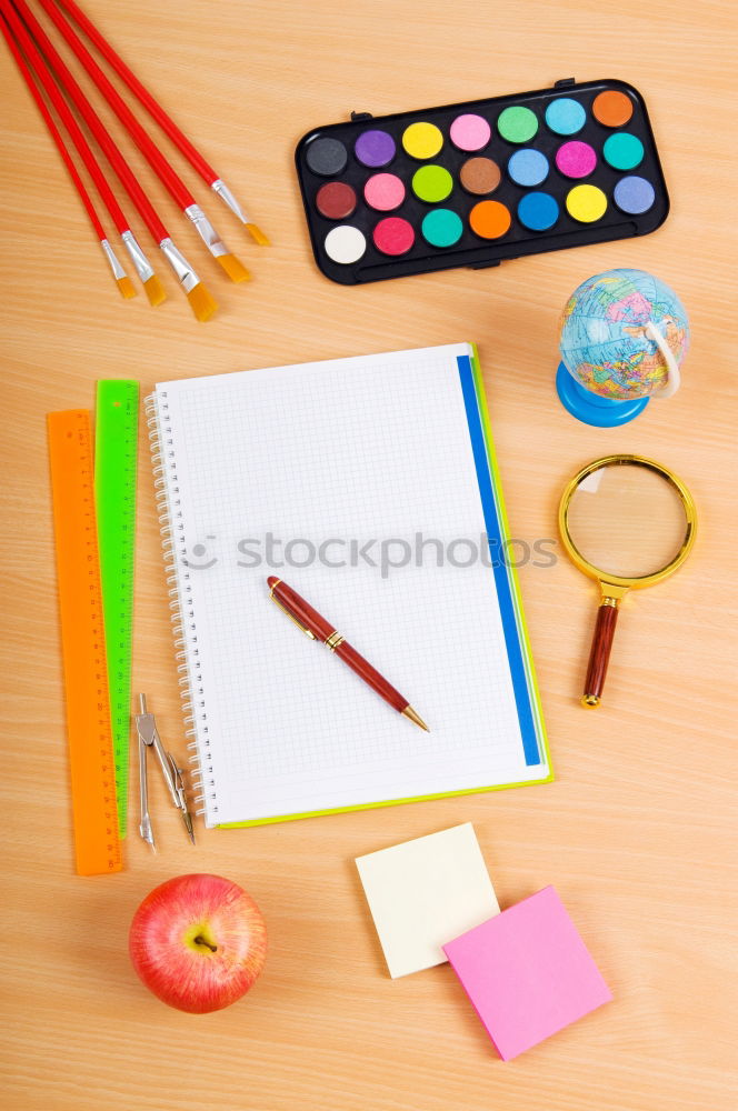 Similar – Notepads, papers, markers and other stationery on wooden table