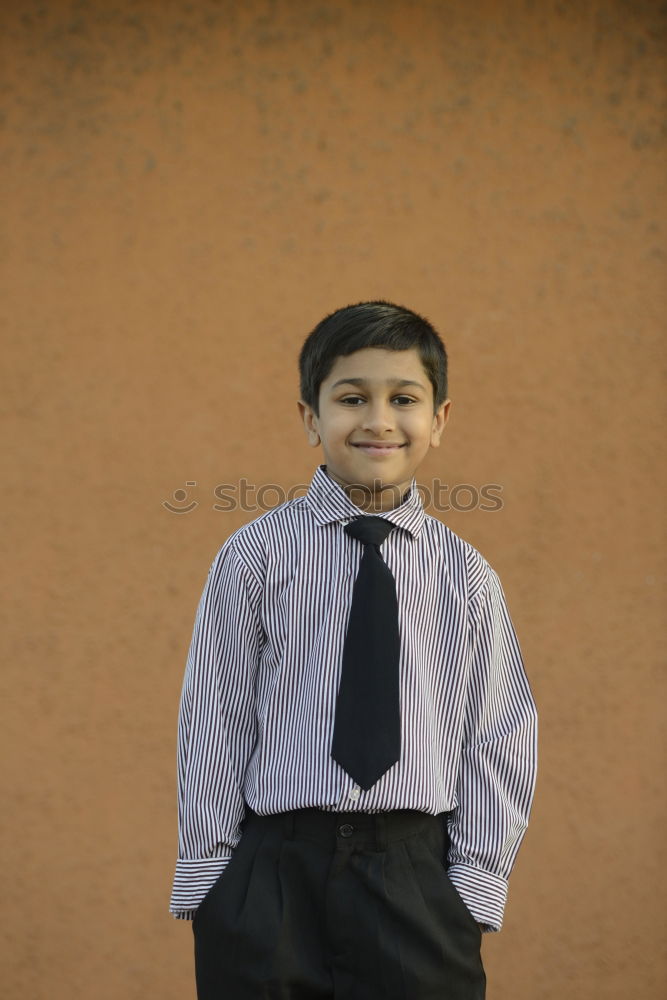 Similar – Cheerful child standing with his backpack on the floor