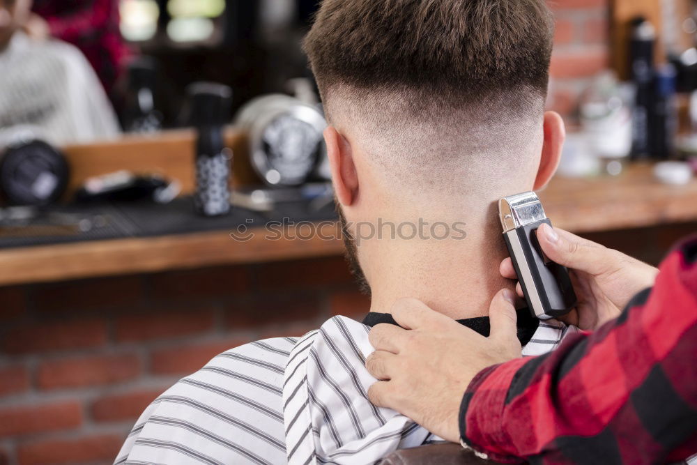 Similar – Foto Bild Detail der Hände eines Friseurs, der einem Kunden mit einem Rasiermesser die Haare schneidet