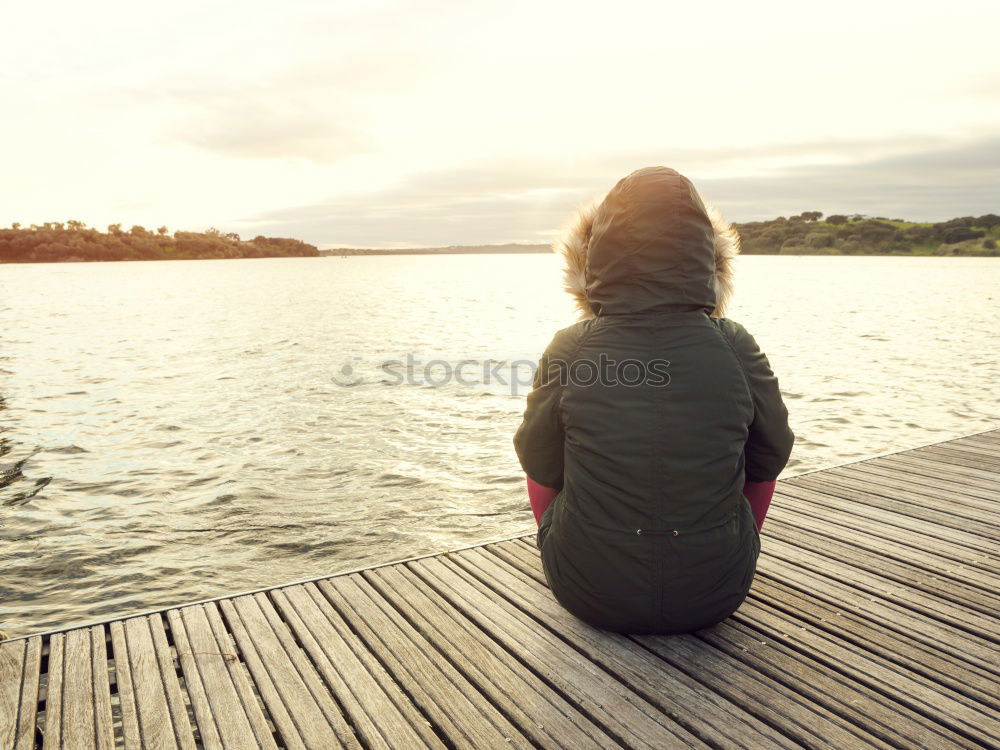 Similar – Image, Stock Photo Thoughtful child sit at waterfront. Back view