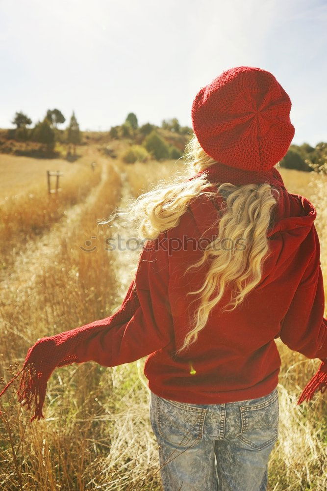 Similar – Image, Stock Photo Back view of a young woman in nature in a sunny autumn day