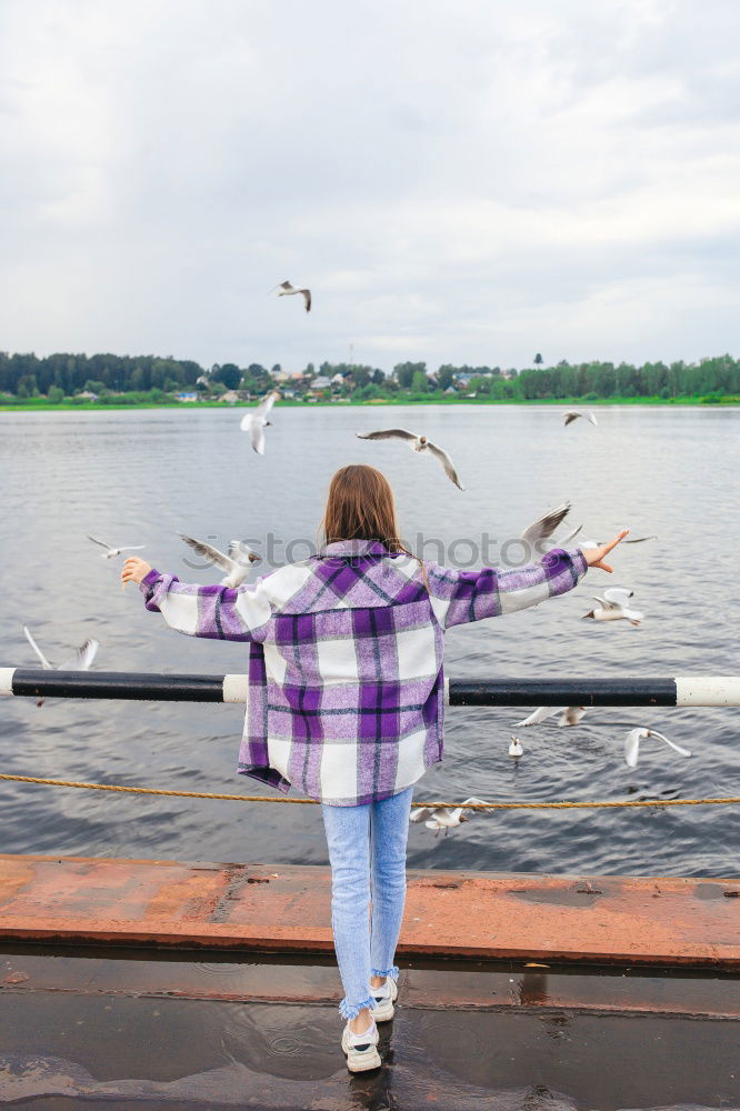 Similar – Image, Stock Photo Young girl sitting on jetty over the lake and dipping feet in water on sunny day in the summertime