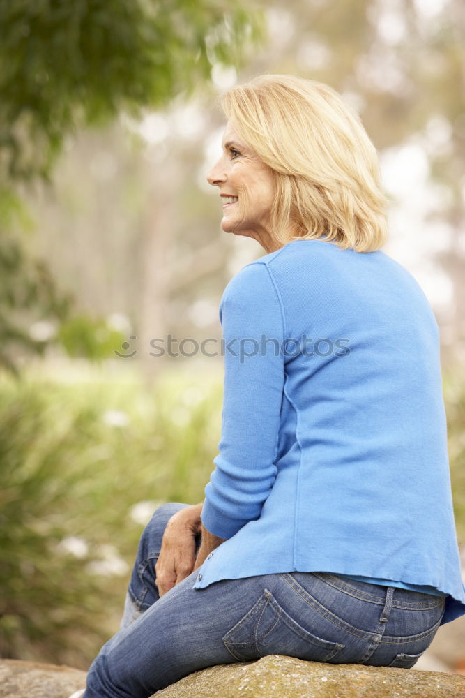 Similar – Happy senior woman sitting on the grass