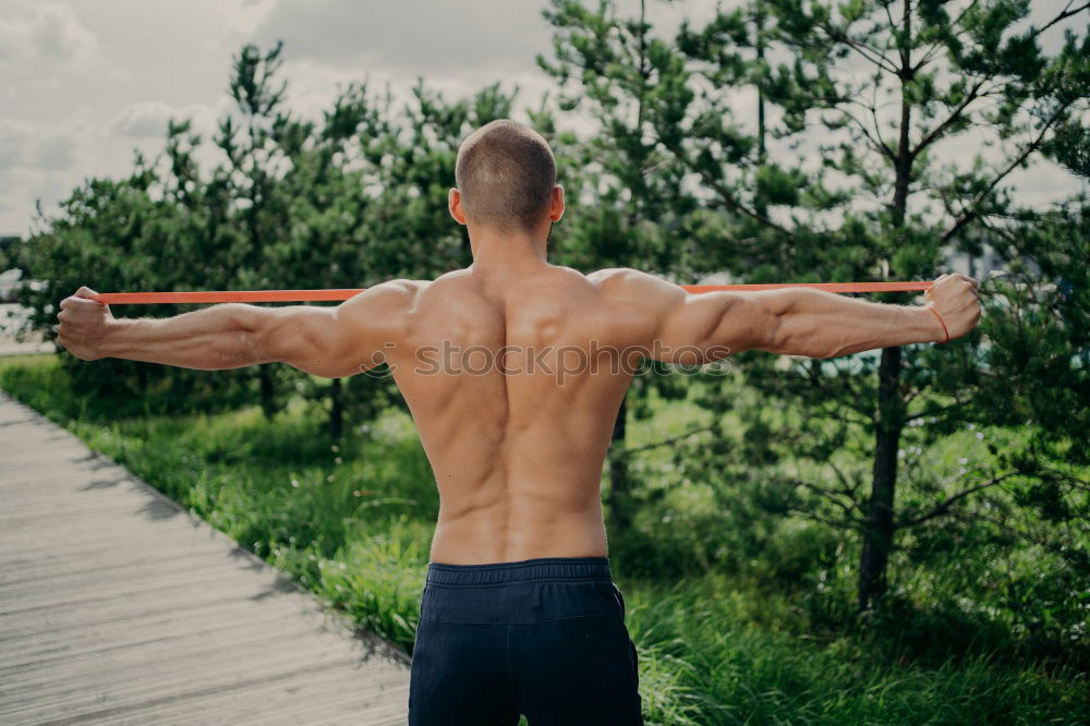 Similar – Young urban athlete warming up before calisthenics training