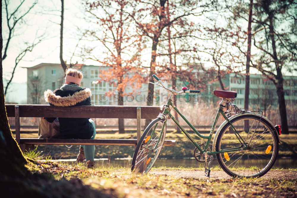 Similar – Front view of a young hipster woman sitting on a park bench relaxing in a sunny day while looking away