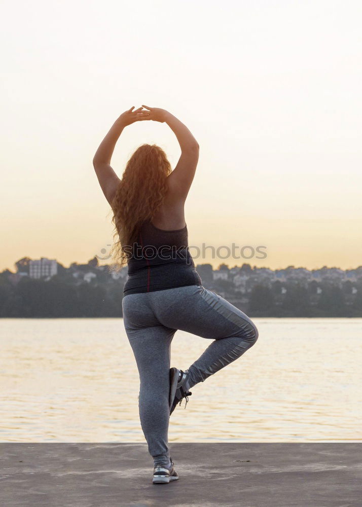 Similar – Woman stretching legs in park