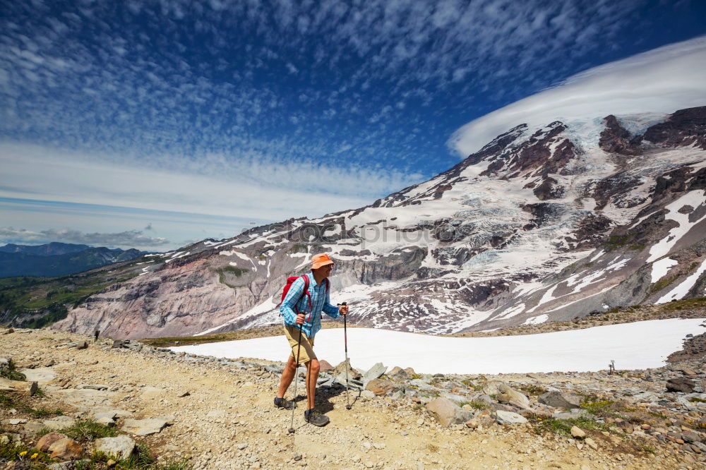 Similar – female hiker going up a mountain with snow.