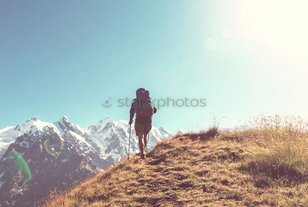 Similar – Woman walks on a mountain path in a sunny day.