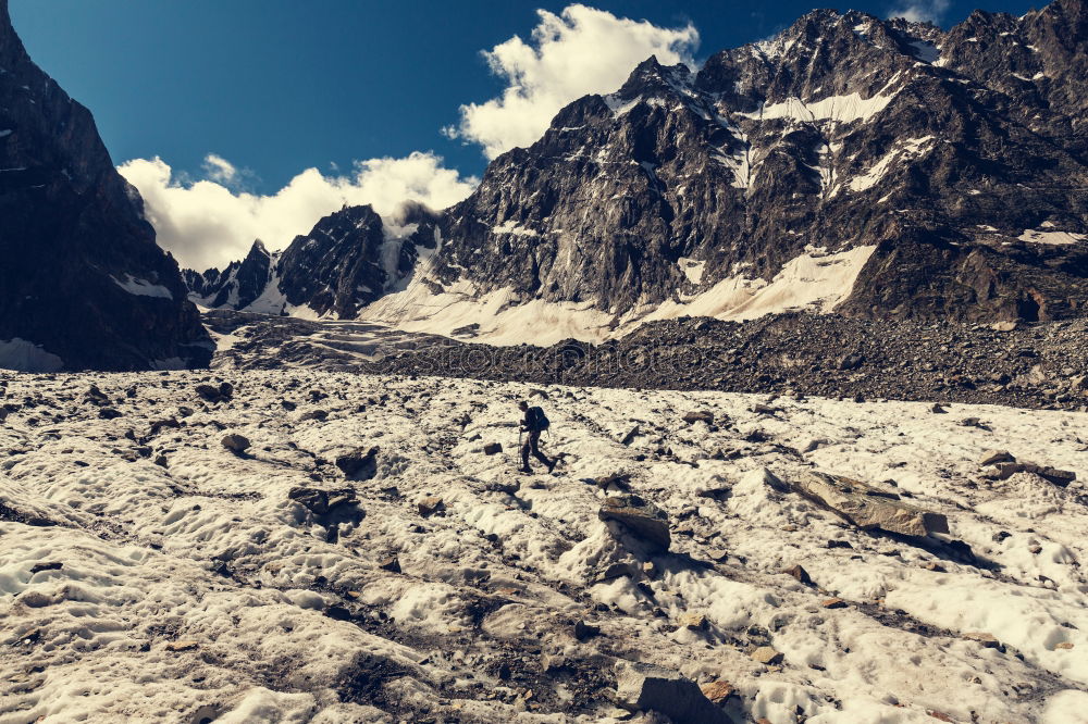 Similar – Man walking in snowy mountains