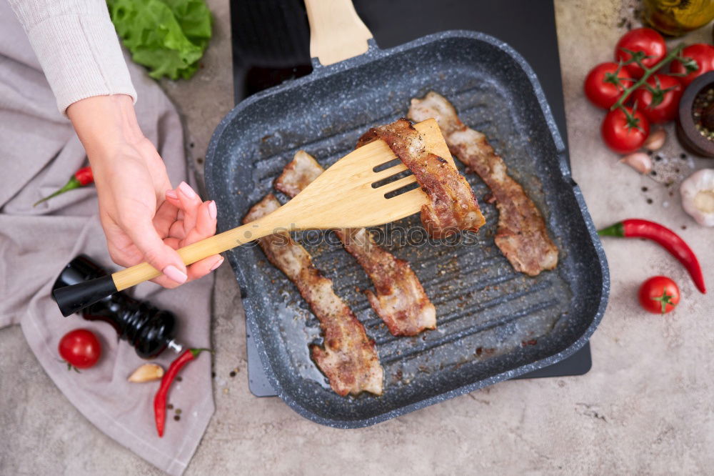 Similar – Man putting steaks into oven