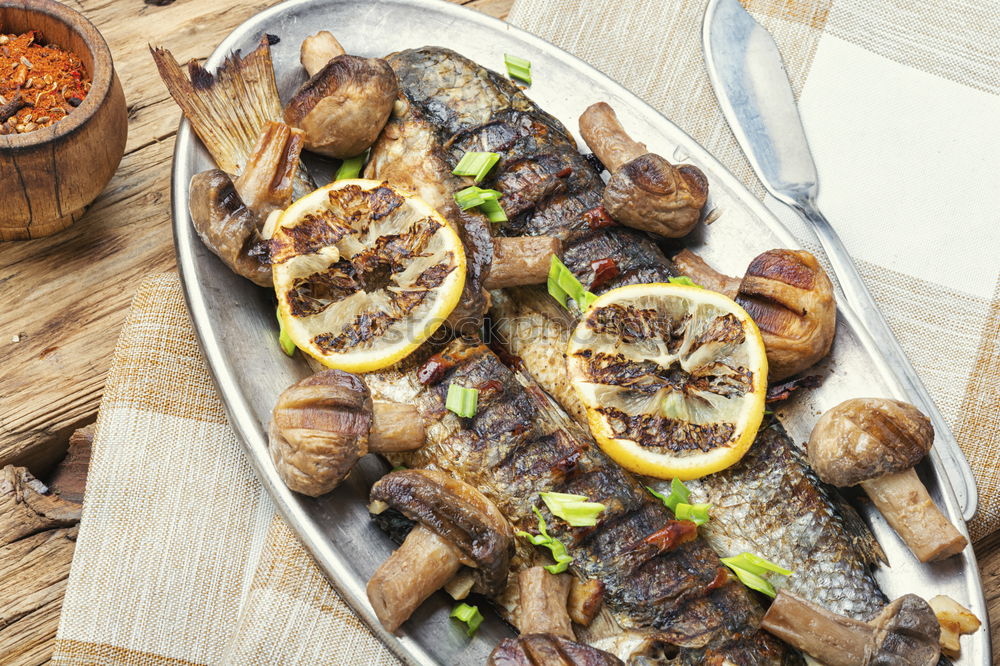 Similar – Image, Stock Photo Grilled sardines on baking tray with ingredients: lemon, garlic and herbs for tasty seafood eating. Cooking preparation of fishes
