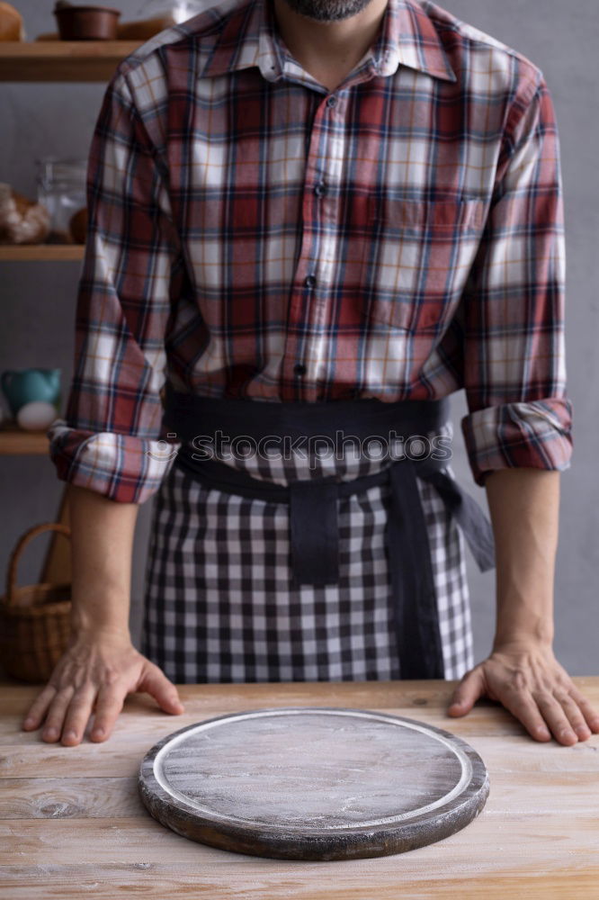 Similar – cook in red uniform holding an empty black frying pan