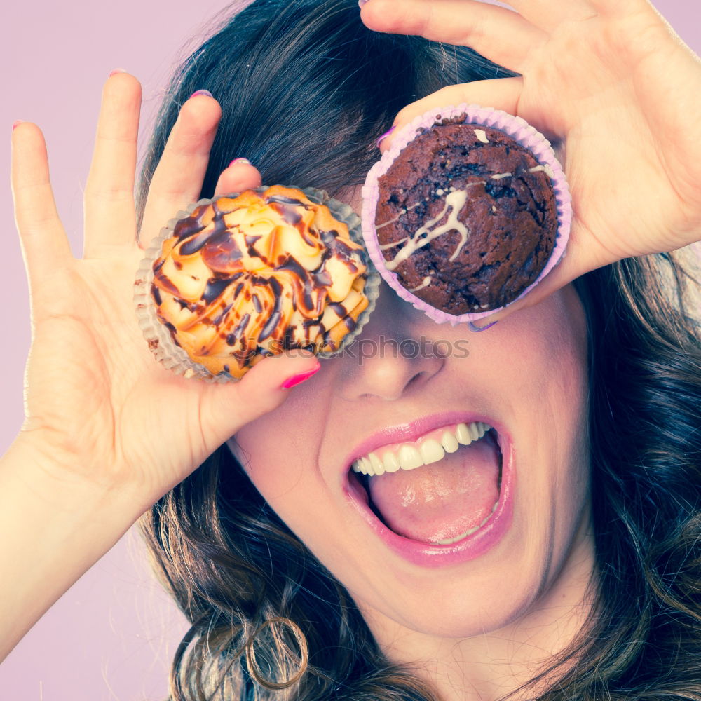 Similar – Young woman pulling funny face holding donuts in hands