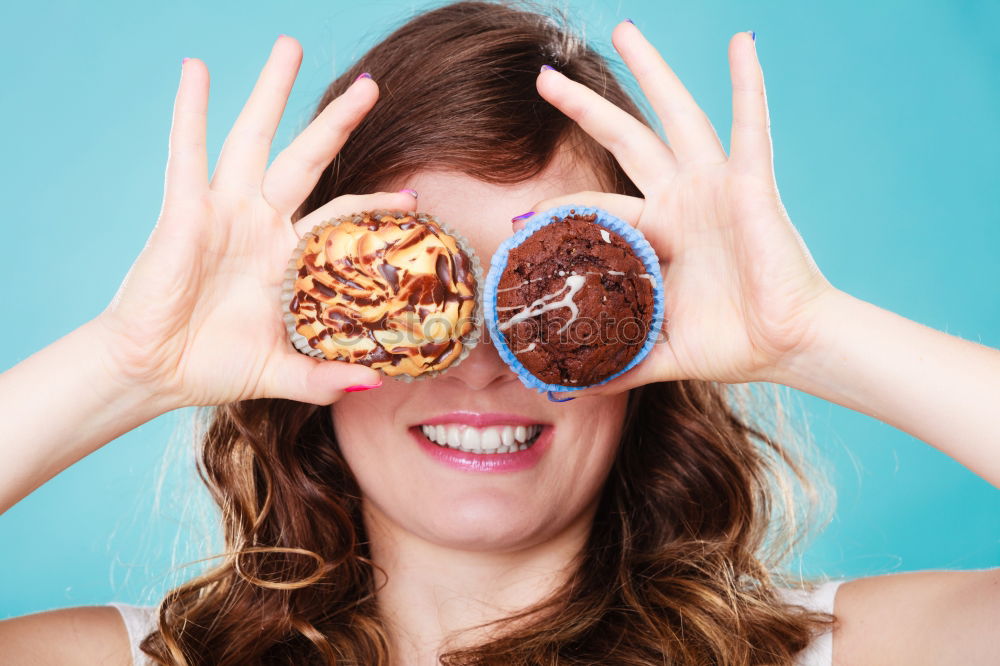 Similar – Young woman pulling funny face holding donuts in hands