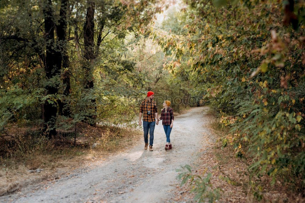 Similar – Elferly fit happy couple hiking through forest together on vacation