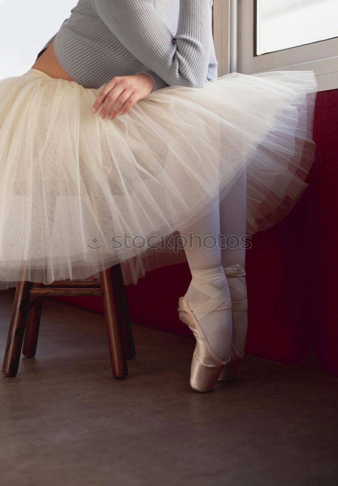 Similar – Ballerina laces up her pointe shoes