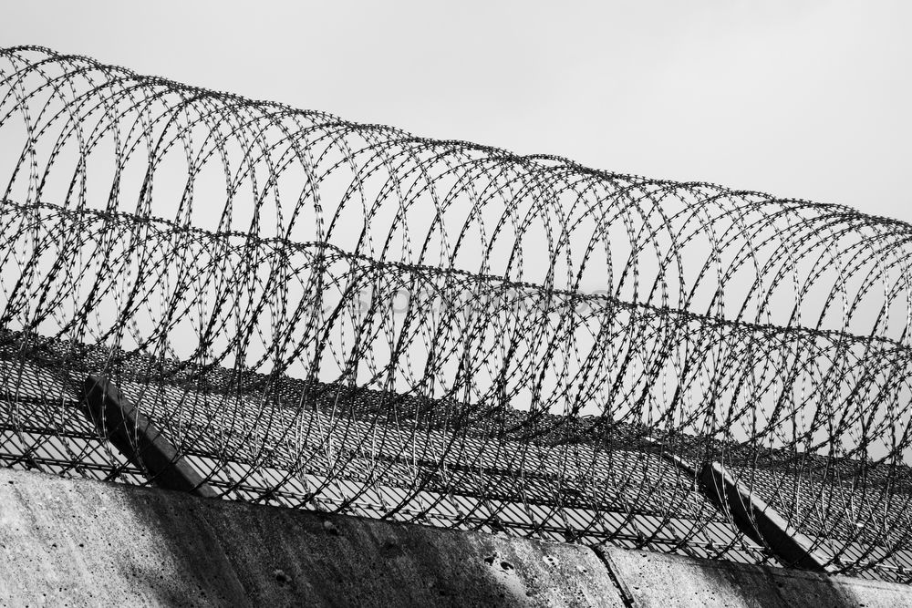 Similar – Prison security fence. Barbed wire security fence. Razor wire jail fence. Barrier border. Boundary security wall. Prison for arrest criminals or terrorists. Private area. Military zone concept.