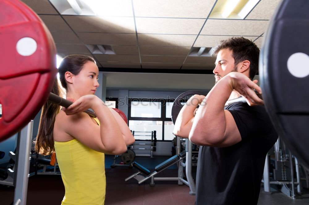 Similar – Female personal trainer helping a young man lift weights