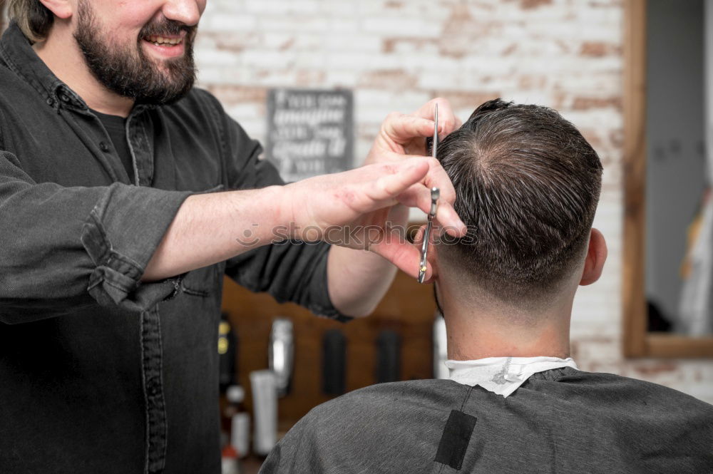 Barber doing face massage to man