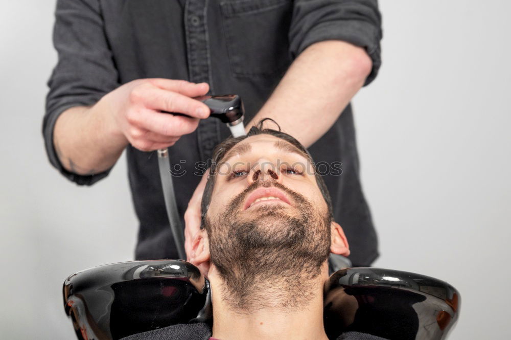 Similar – Foto Bild Detail der Hände eines Friseurs, der einem Kunden mit einem Rasiermesser die Haare schneidet