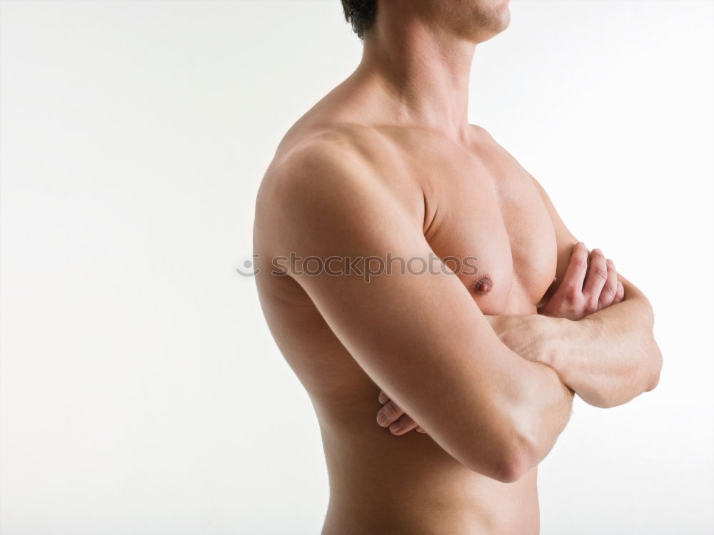 Similar – young woman with very short hair stands naked in front of light turquoise wall in pose with half raised arms