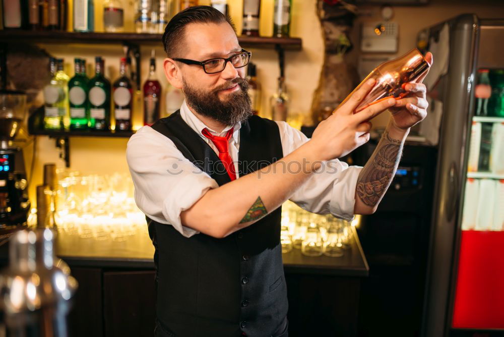 Barman is making cocktail at night club.