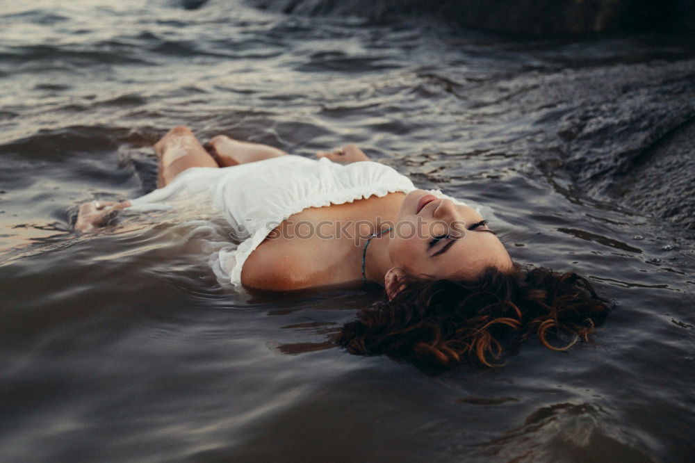 Similar – Image, Stock Photo Portrait of a young blonde woman in a white summer dress in a lake on the surface