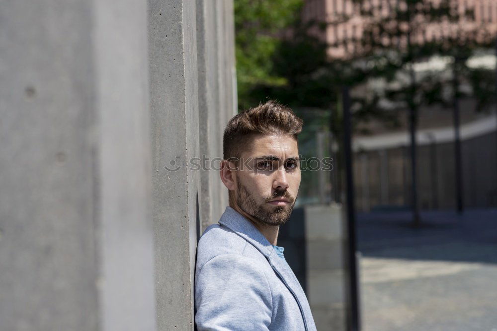 Similar – Young bearded man, model of fashion, in urban background wearing casual clothes while leaning on a wall and looking aside