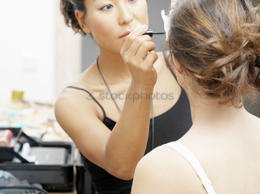 Similar – Young gender fluid person applying makeup at home