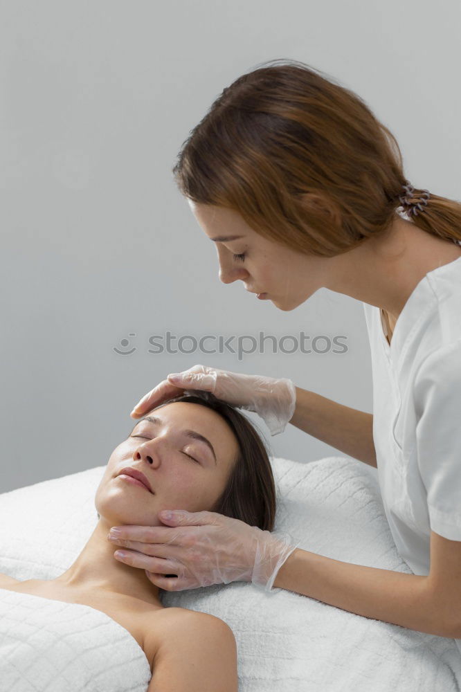 Similar – Massage therapist doing lymphatic drainage treatment to woman