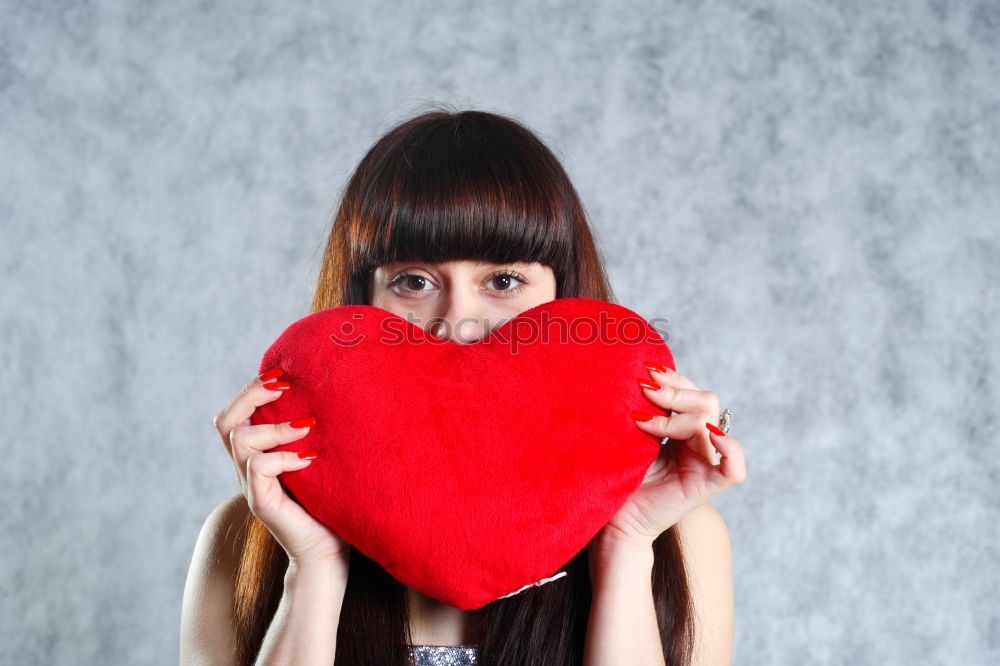 Similar – Image, Stock Photo Beautiful young woman holding a red heart