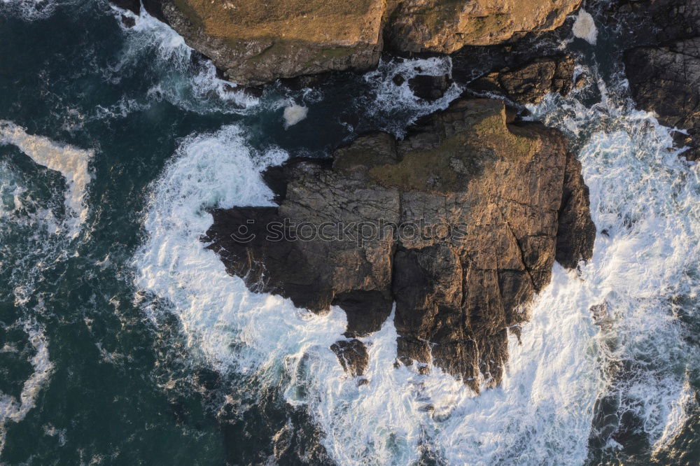 Similar – Aerial views of a coastline with waves and rocks