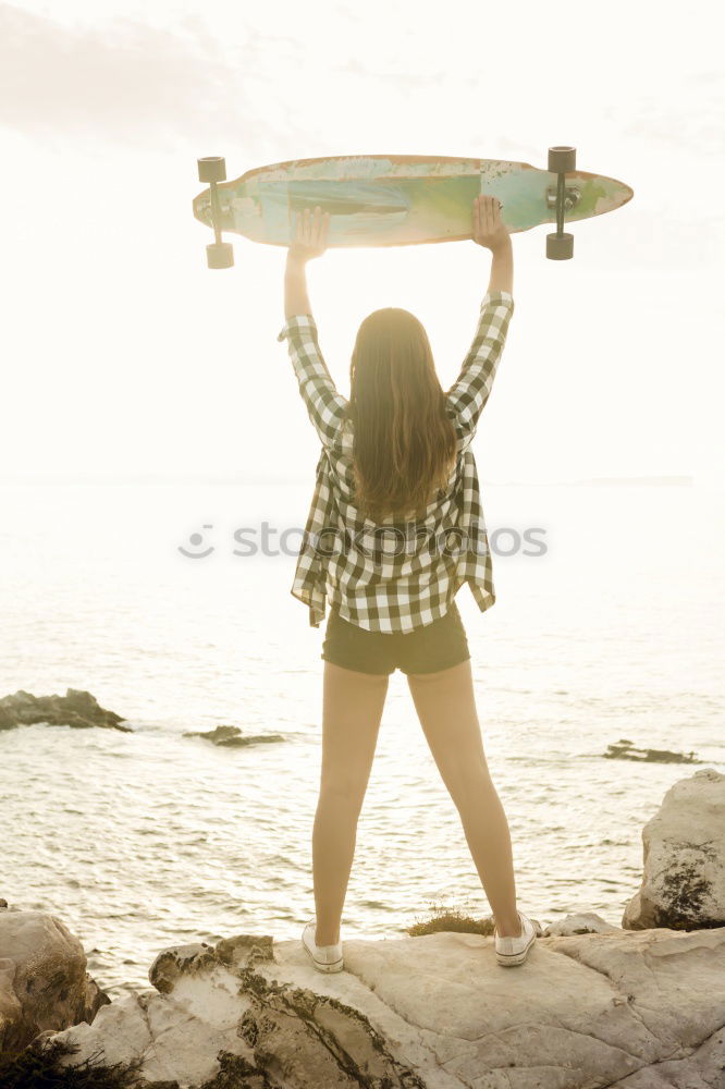 Similar – Man standing with skateboard at shore