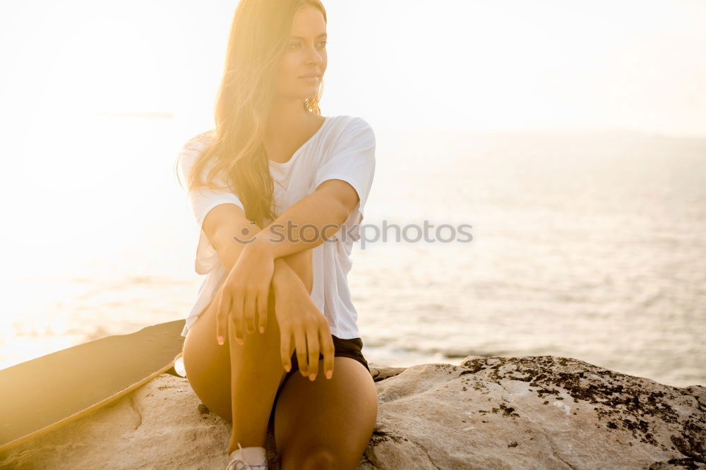 Similar – Cute woman touching her hair while the wind moves it.