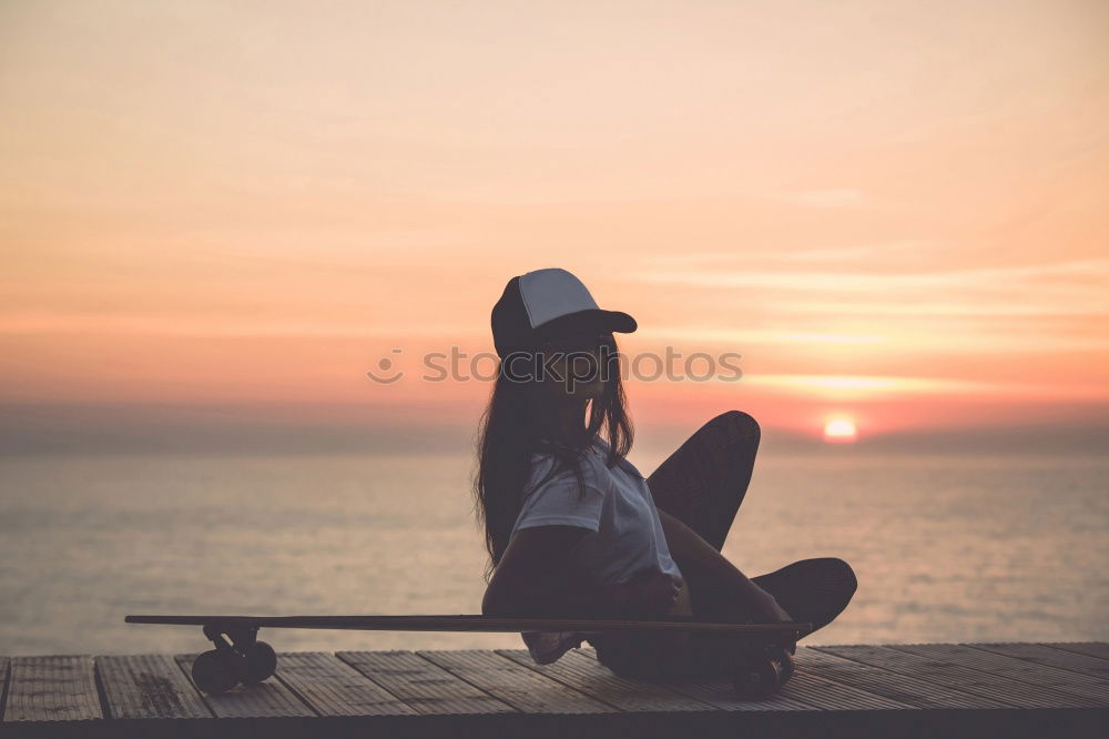 Similar – Hipster guy sitting on railing browsing with his smart phone