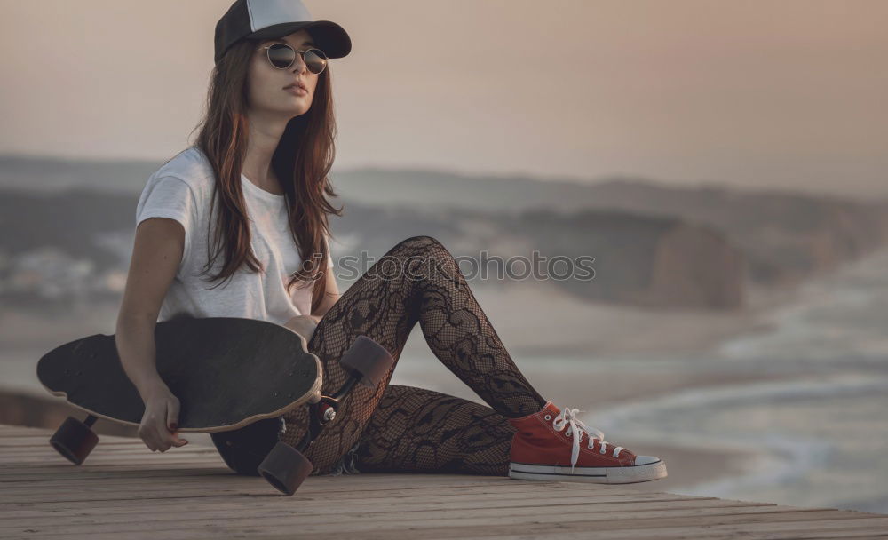 Similar – Happy female riding skate board in street