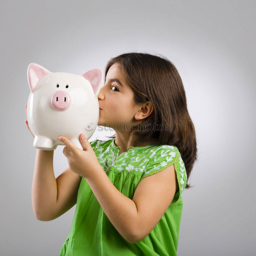 Similar – Thoughtful confused black woman with piggy bank