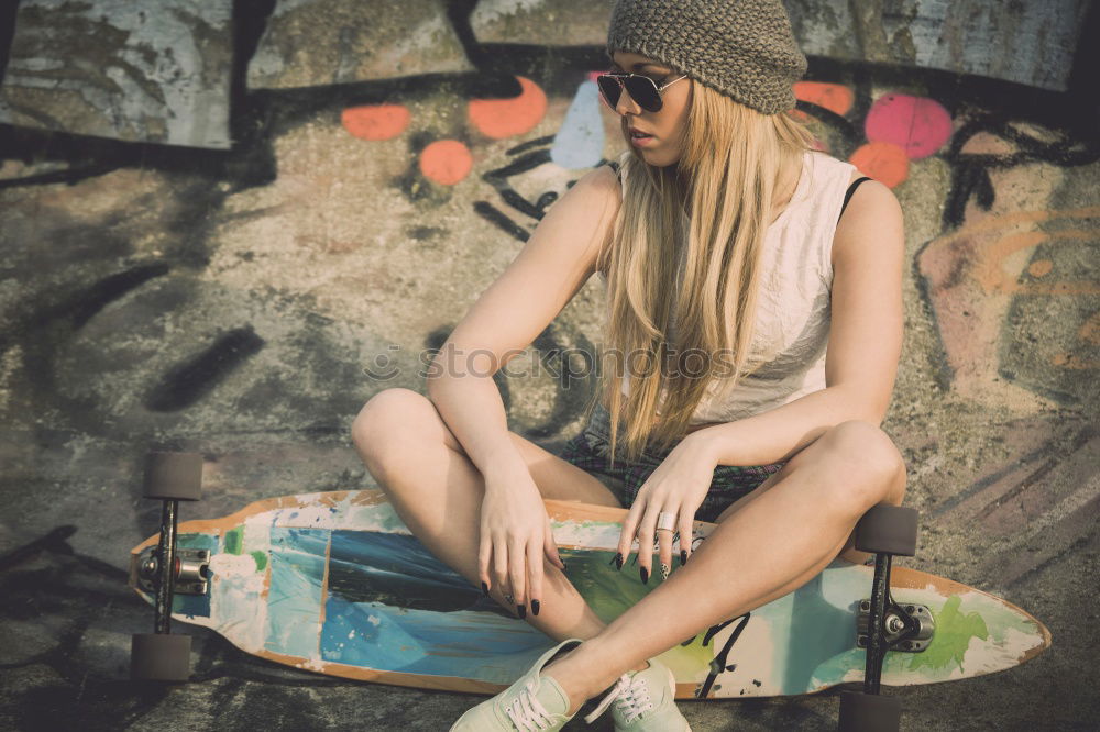 Similar – Image, Stock Photo A beautiful teenager is sitting on a skateboard in a special area of the Park. A boy is resting after riding in a skatepark. Active rest in the fresh air