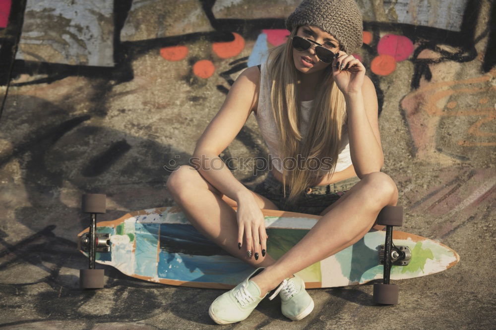 Similar – Image, Stock Photo A beautiful teenager is sitting on a skateboard in a special area of the Park. A boy is resting after riding in a skatepark. Active rest in the fresh air