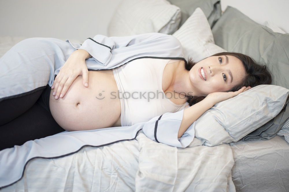 Similar – Pregnant woman touching her belly