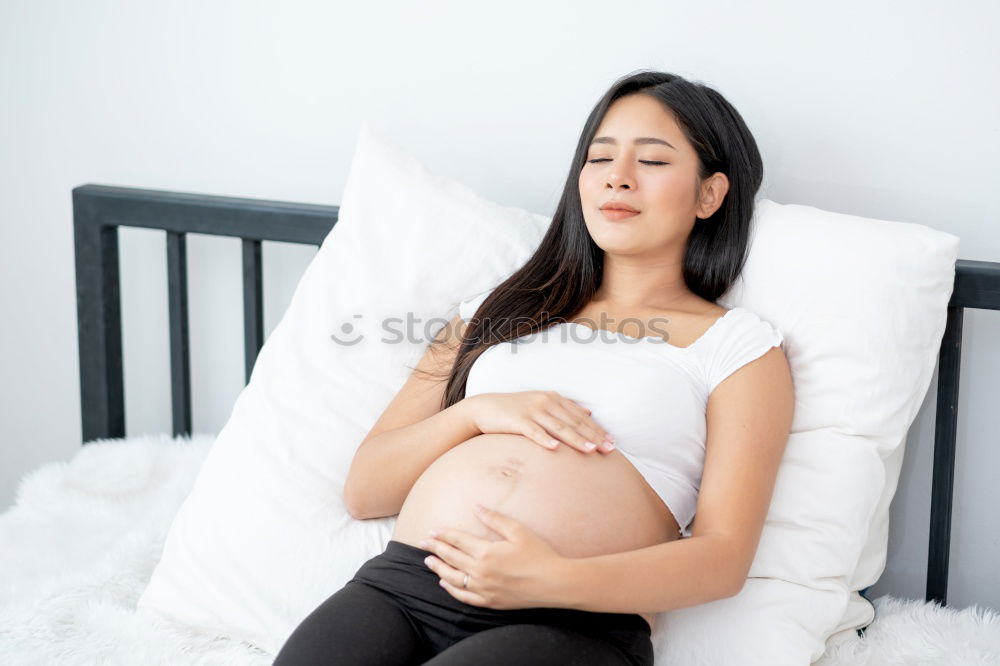 Similar – Pregnant woman touching her belly