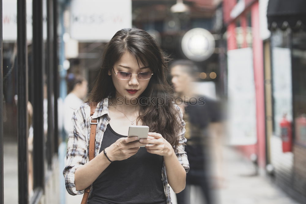 Image, Stock Photo Fashionable young woman reading a SMS