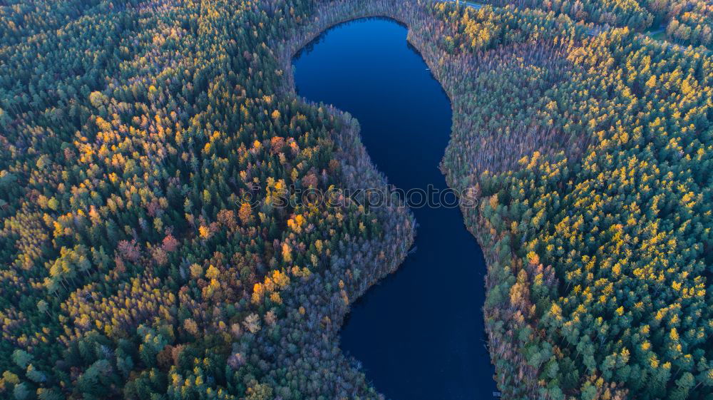 Similar – Curved road in fall forest and village.