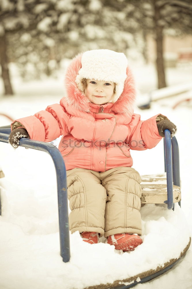 Similar – Teenage girl pulling sled with her little sister through forest