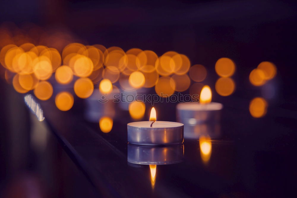 Similar – Advent arrangement with four candles. In the background the blurred lights of the Christmas tree.