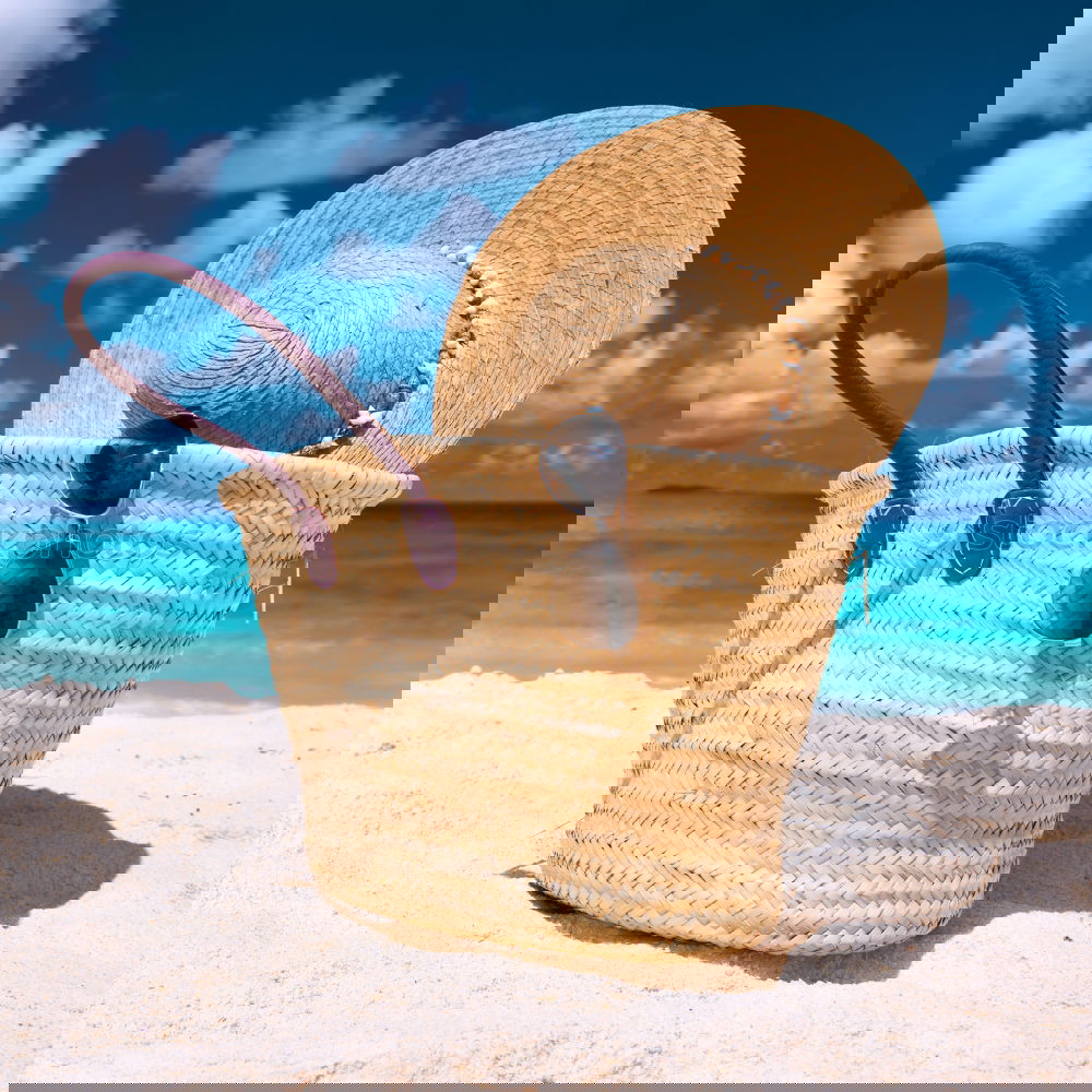 Similar – Image, Stock Photo Several beach accessories, bag, hat and color towel put on the sand close to the sea water