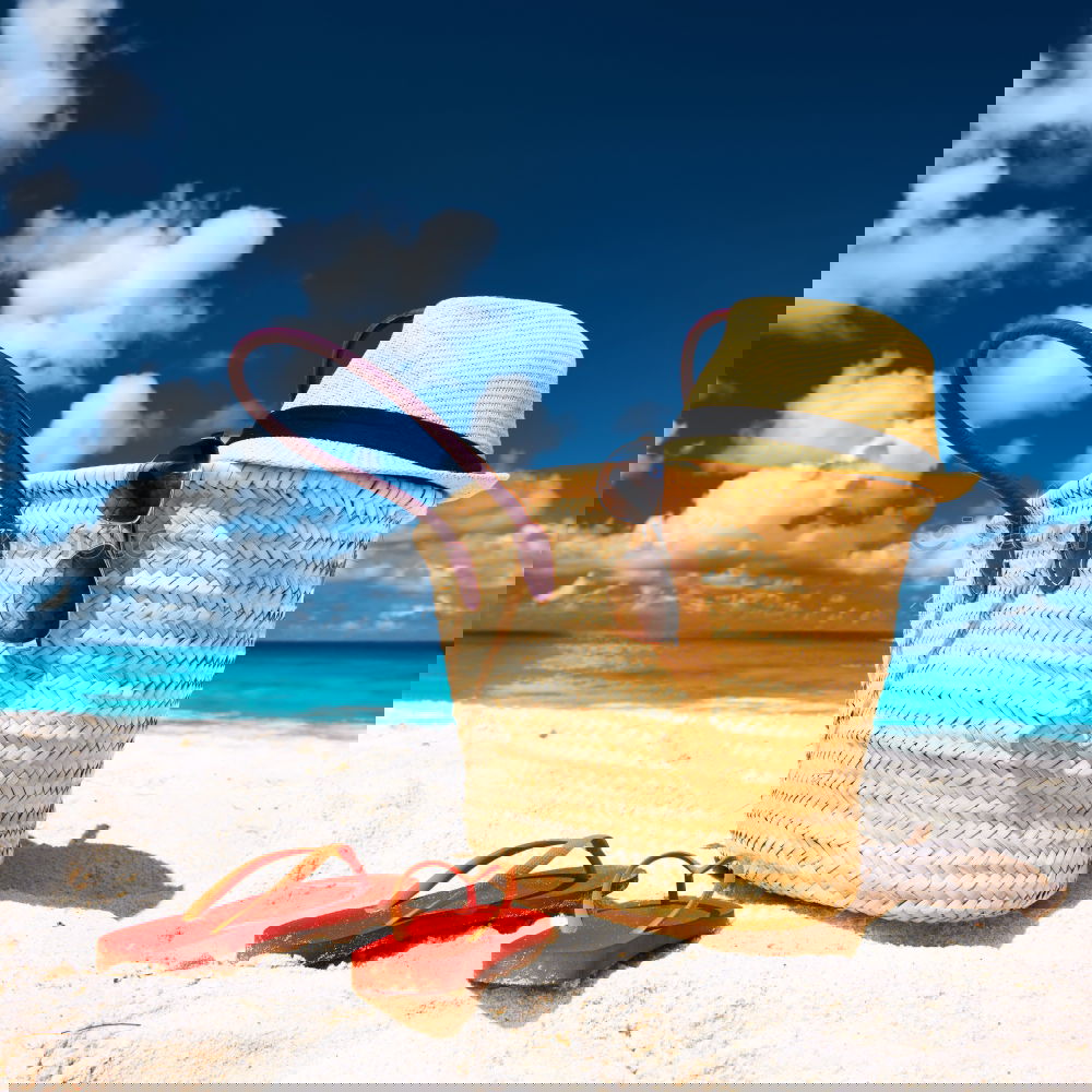 Similar – Image, Stock Photo Several beach accessories, bag, hat and color towel put on the sand close to the sea water