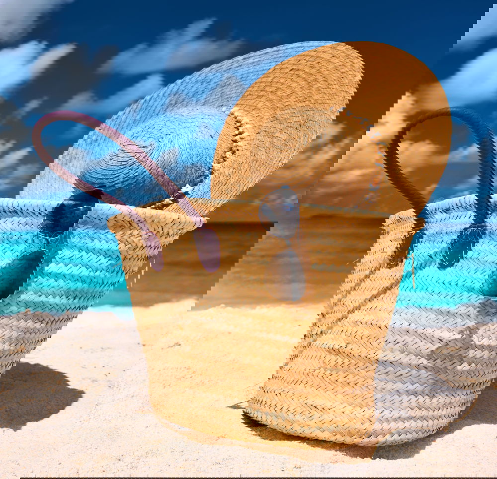 Similar – Image, Stock Photo Several beach accessories, bag, hat and color towel put on the sand close to the sea water