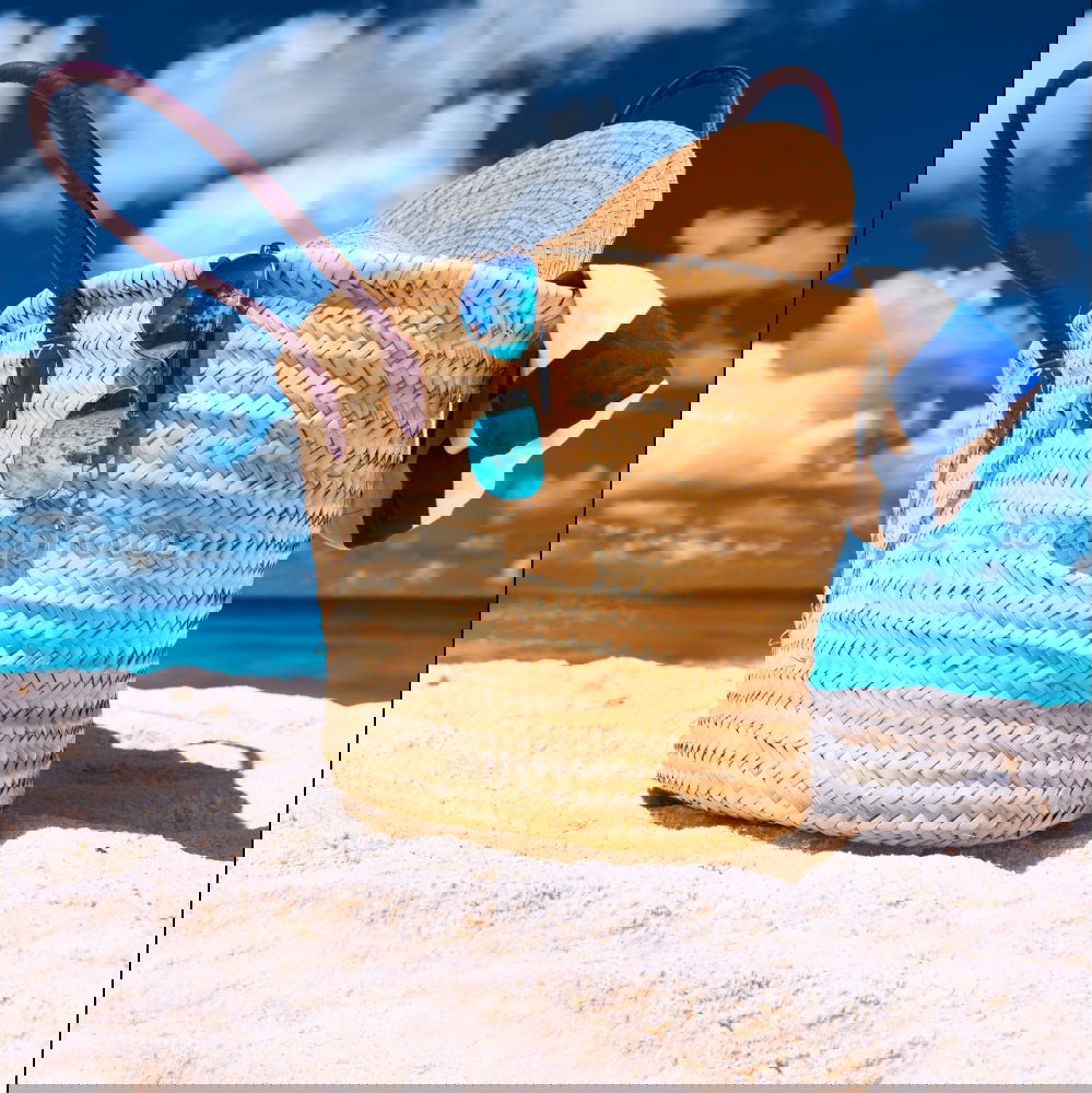 Image, Stock Photo Several beach accessories, bag, hat and color towel put on the sand close to the sea water
